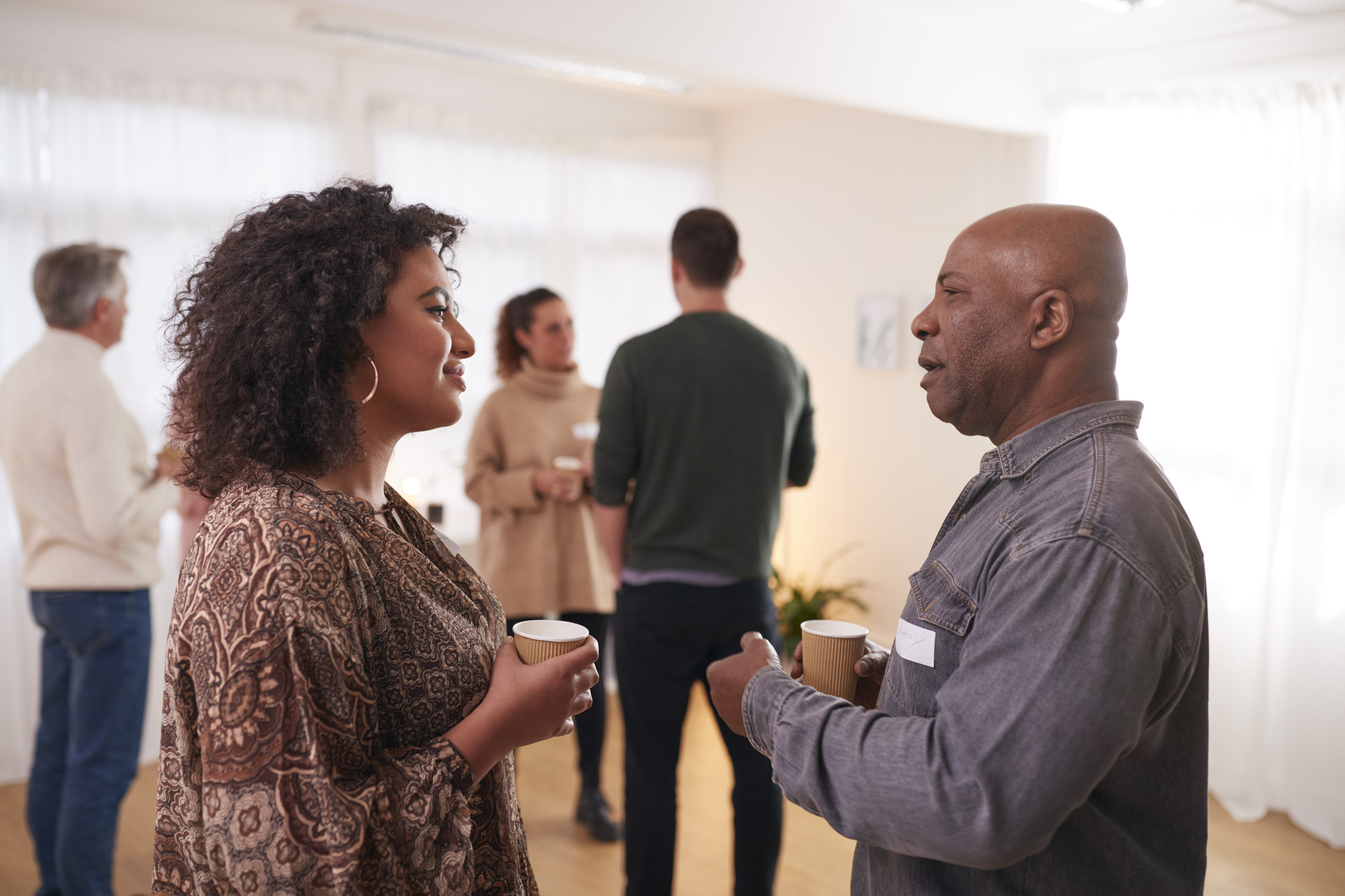 Residents talking before a community meeting